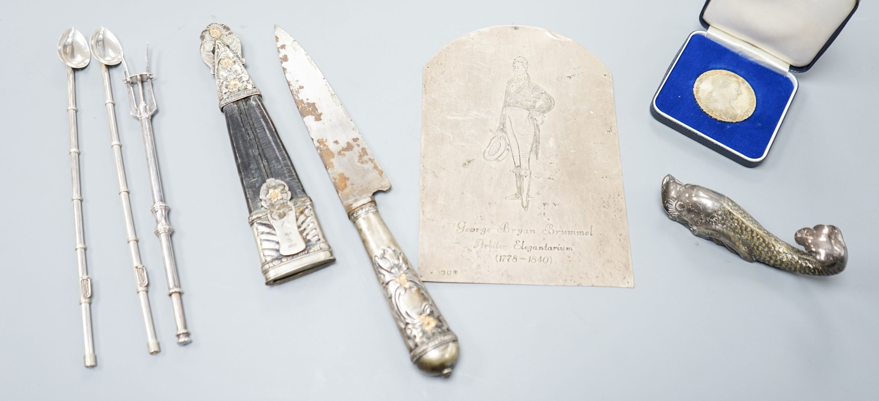 A silver plaque, two mate straws, knife etc.